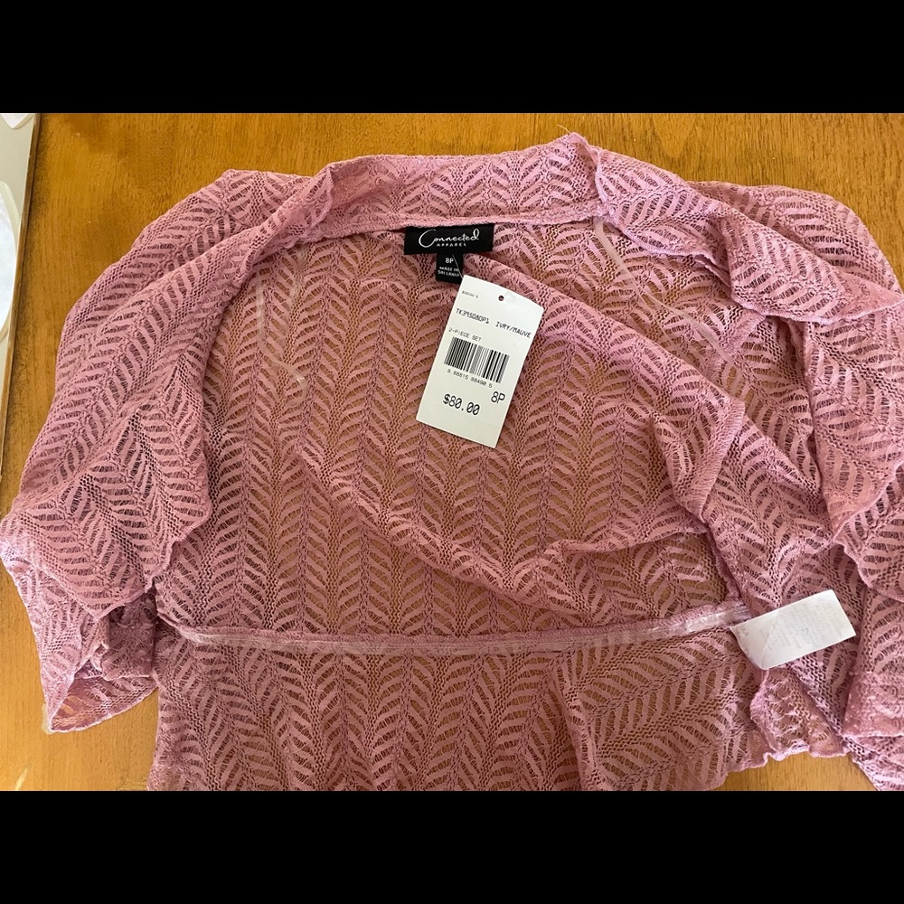 Pink shrug with tags, never worn.